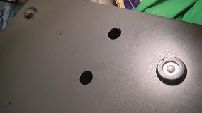 Screw holes for the left drive bay are located on the underside of the chassis